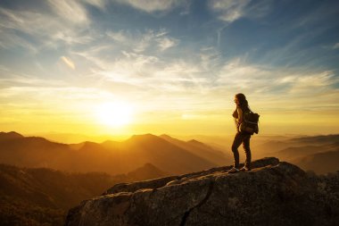 Hiker meets the sunset on the Moro rock in Sequoia national park, California, USA. clipart