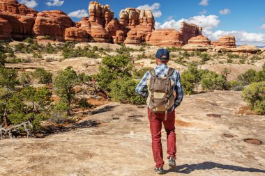 Hiker in Canyonlands National park, needles in the sky, in Utah, clipart