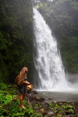 Woman near Nung Nung waterfal on Bali, Indonesia