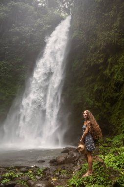 Woman near Nung Nung waterfal on Bali, Indonesia