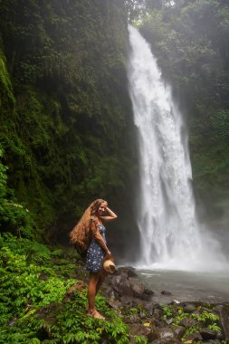 Woman near Nung Nung waterfal on Bali, Indonesia