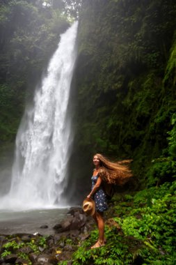 Woman near Nung Nung waterfal on Bali, Indonesia