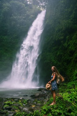 Woman near Nung Nung waterfal on Bali, Indonesia