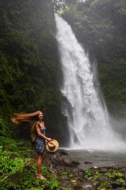 Woman near Nung Nung waterfal on Bali, Indonesia