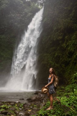 Woman near Nung Nung waterfal on Bali, Indonesia