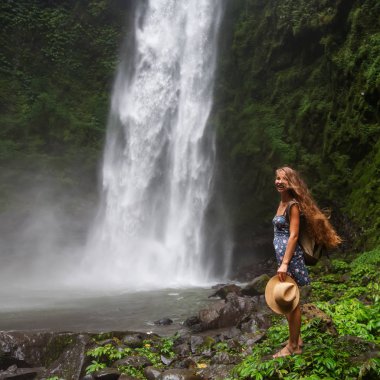 Woman near Nung Nung waterfal on Bali, Indonesia