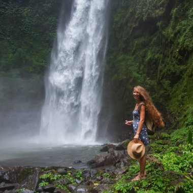 Woman near Nung Nung waterfal on Bali, Indonesia