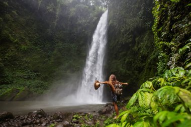 Woman near Nung Nung waterfal on Bali, Indonesia
