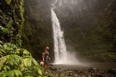Woman near Nung Nung waterfal on Bali, Indonesia