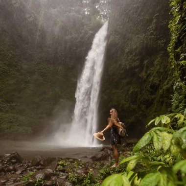Woman near Nung Nung waterfal on Bali, Indonesia