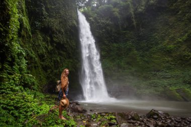 Woman near Nung Nung waterfal on Bali, Indonesia