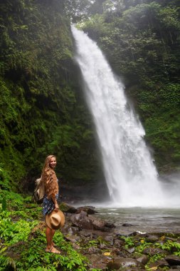 Woman near Nung Nung waterfal on Bali, Indonesia