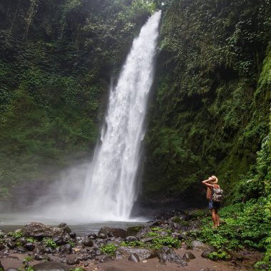 Woman near Nung Nung waterfal on Bali, Indonesia