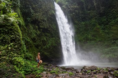 Woman near Nung Nung waterfal on Bali, Indonesia
