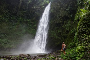 Woman near Nung Nung waterfal on Bali, Indonesia