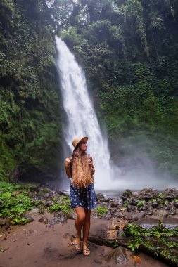 Woman near Nung Nung waterfal on Bali, Indonesia