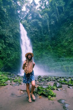 Woman near Nung Nung waterfal on Bali, Indonesia