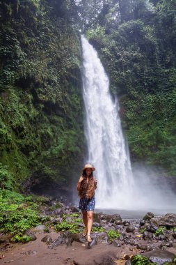 Woman near Nung Nung waterfal on Bali, Indonesia