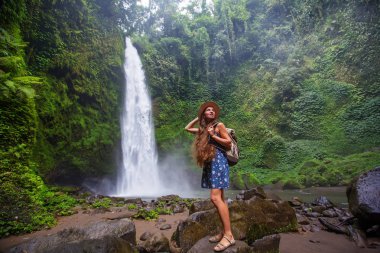 Woman near Nung Nung waterfal on Bali, Indonesia