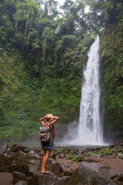 Woman near Nung Nung waterfal on Bali, Indonesia
