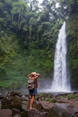 Woman near Nung Nung waterfal on Bali, Indonesia