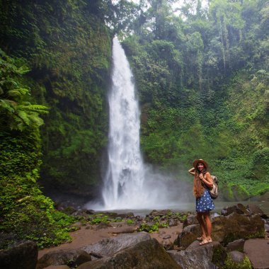 Woman near Nung Nung waterfal on Bali, Indonesia