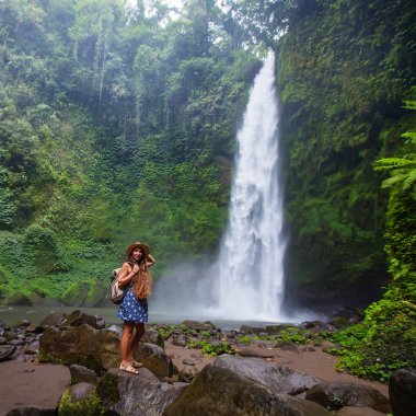 Woman near Nung Nung waterfal on Bali, Indonesia