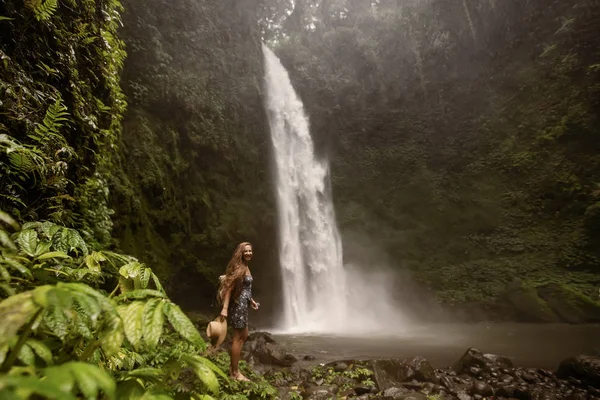Woman near Nung Nung waterfal on Bali, Indonesia