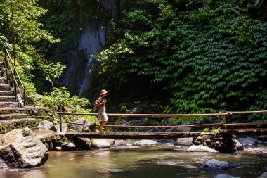 Woman near Nung Nung waterfal on Bali, Indonesia