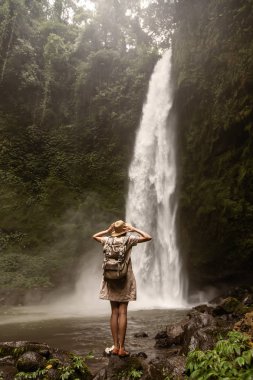Woman near Nung Nung waterfal on Bali, Indonesia
