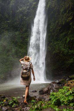 Woman near Nung Nung waterfal on Bali, Indonesia