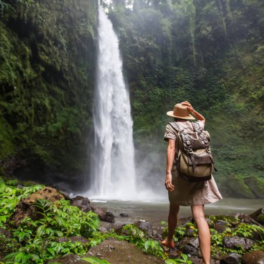 Woman near Nung Nung waterfal on Bali, Indonesia