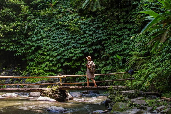 Woman near Nung Nung waterfal on Bali, Indonesia