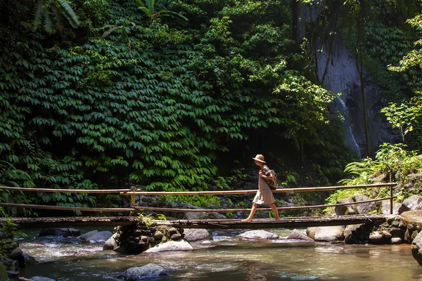 Woman near Nung Nung waterfal on Bali, Indonesia