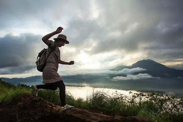 Batur, Bali, Indon dağının tepesinden gün doğumunun tadını çıkaran kadın