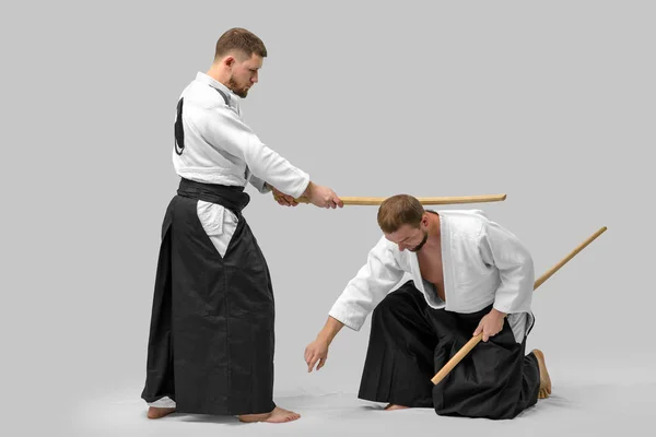 Dos hombres caucásicos practican aikido con Bokken (aislamiento p — Foto de Stock