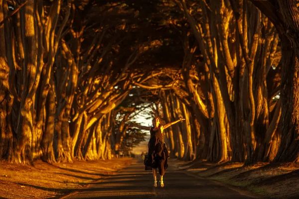 Happy girl in a tunnel with trees — Stock Photo, Image