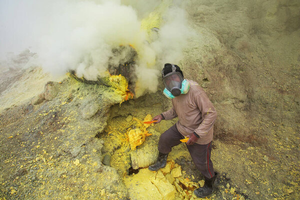 People mining sulphur in Ijen volcano, Java , Indonesia 