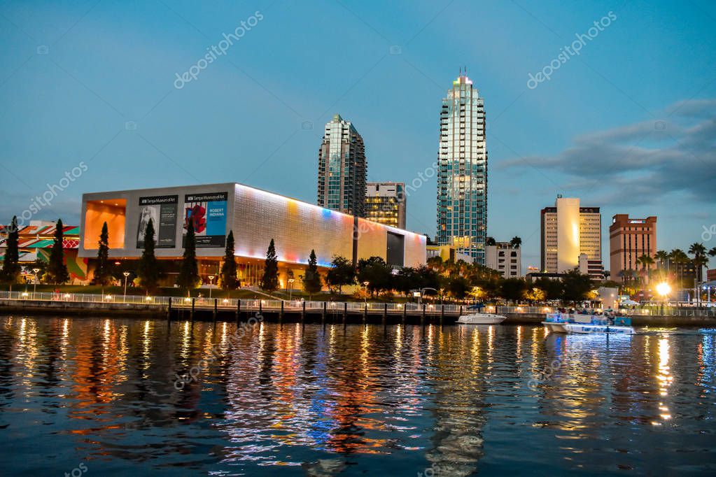 Tampa Bay, Florida. January 05, 2019. Colorful illuminated Tampa Museum of Art and downtown buildings reflecting on the water.