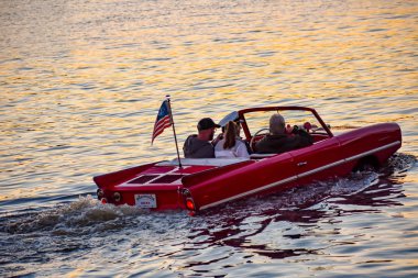 Orlando, Florida; January 11, 2019 People enjoying ride in red amphibious car at Lake Buena Vista area (3) clipart