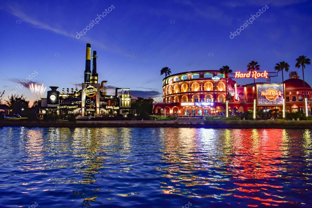 Orlando, Florida. February 05, 2019. Fireworks , Chocolate Emporium restaurant and Hard Rock Cafe on blue night background at Universal Studios area