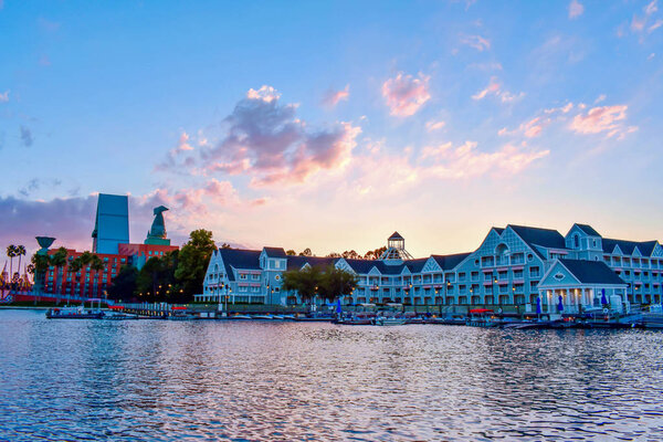 Taxi boat sailing on lake, with background of villas, pirate ship and lighthouse at Lake Buena Vista area (2)