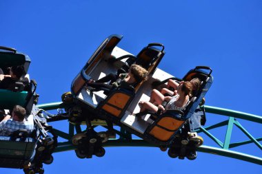 Tampa, Florida. October 25, 2018 .People enjoying terrific Cobras's Curse Roller Coaster in amusement Bush Gardens Tampa Bay clipart