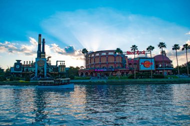 Orlando, Florida. 22 Mayıs 2019. Ön planda göl ile Florida Universal Orlando Resort gün batımı arka plan üzerinde Hard Rock Cafe. (2)