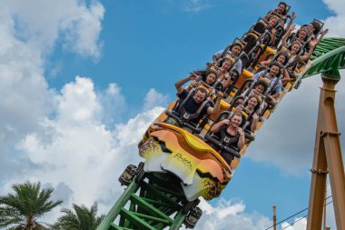 Tampa Bay, Florida. August 08, 2019. People having fun amazing Cheetah Hunt rollercoaster , during last summer vacation 24 clipart