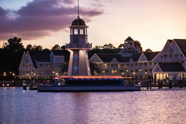 Orlando, Florida. October 11, 2019. Taxi boat, lighthouse and villas on colorful sunset background at Lake Buena Vista (55)