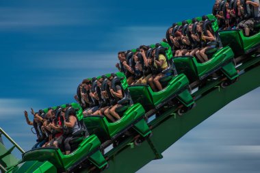 Orlando, Florida. October 9, 2019. People having fun terrific The Incredible Hulk rollercoaster at Island of Adventure. clipart