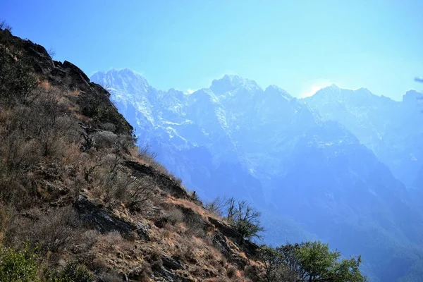 Hiking in Tiger Leaping Gorge. Mountains and river. Between Xianggelila and Lijiang City, Yunnan Province, Tibet, China.