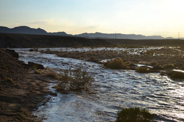 Huge Flash flood in Mitzpe Ramon Crater, Negev desert in South Israel, streams floods of water in the desert wilderness