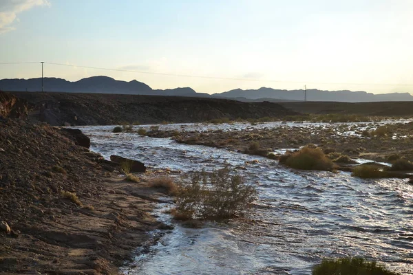 Huge Flash flood in Mitzpe Ramon Crater, Negev desert in South Israel, streams floods of water in the desert wilderness